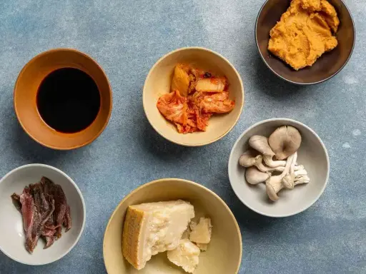 Składniki bogate w umami: sos sojowy, kimchi, miso, grzyby, parmezan i sardele.