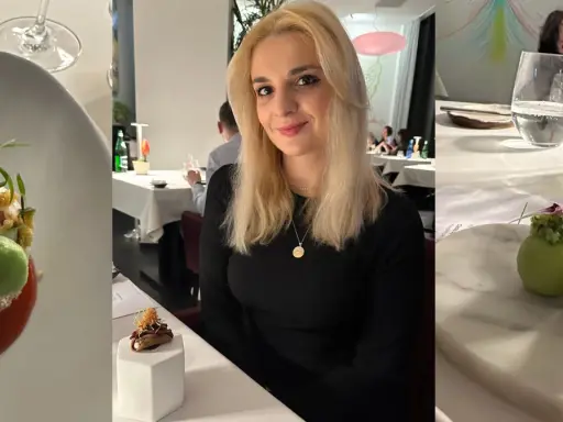 Kobieta w eleganckiej restauracji z gwiazdką Michelin w Polsce. Na stole wykwintne dania i napoje.