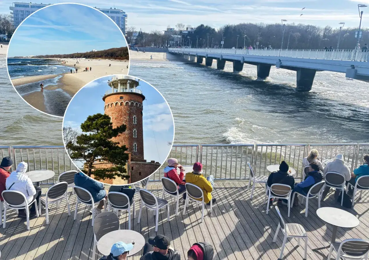 Gdzie nad morze? Widok na plażę, latarnię i molo. Ludzie siedzą przy stolikach na tarasie z widokiem na fale.